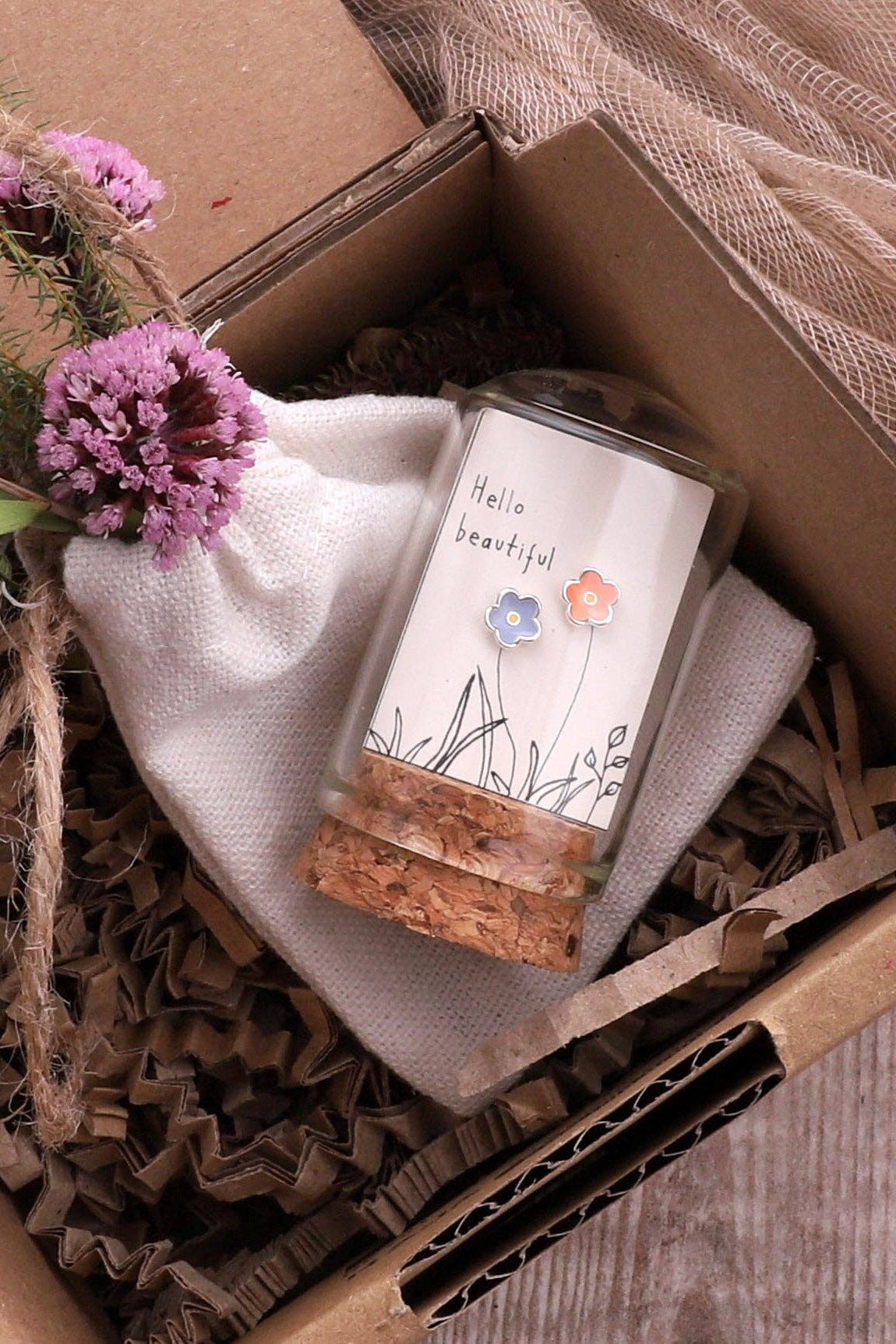 Candle in a decorative box with flowers and natural elements